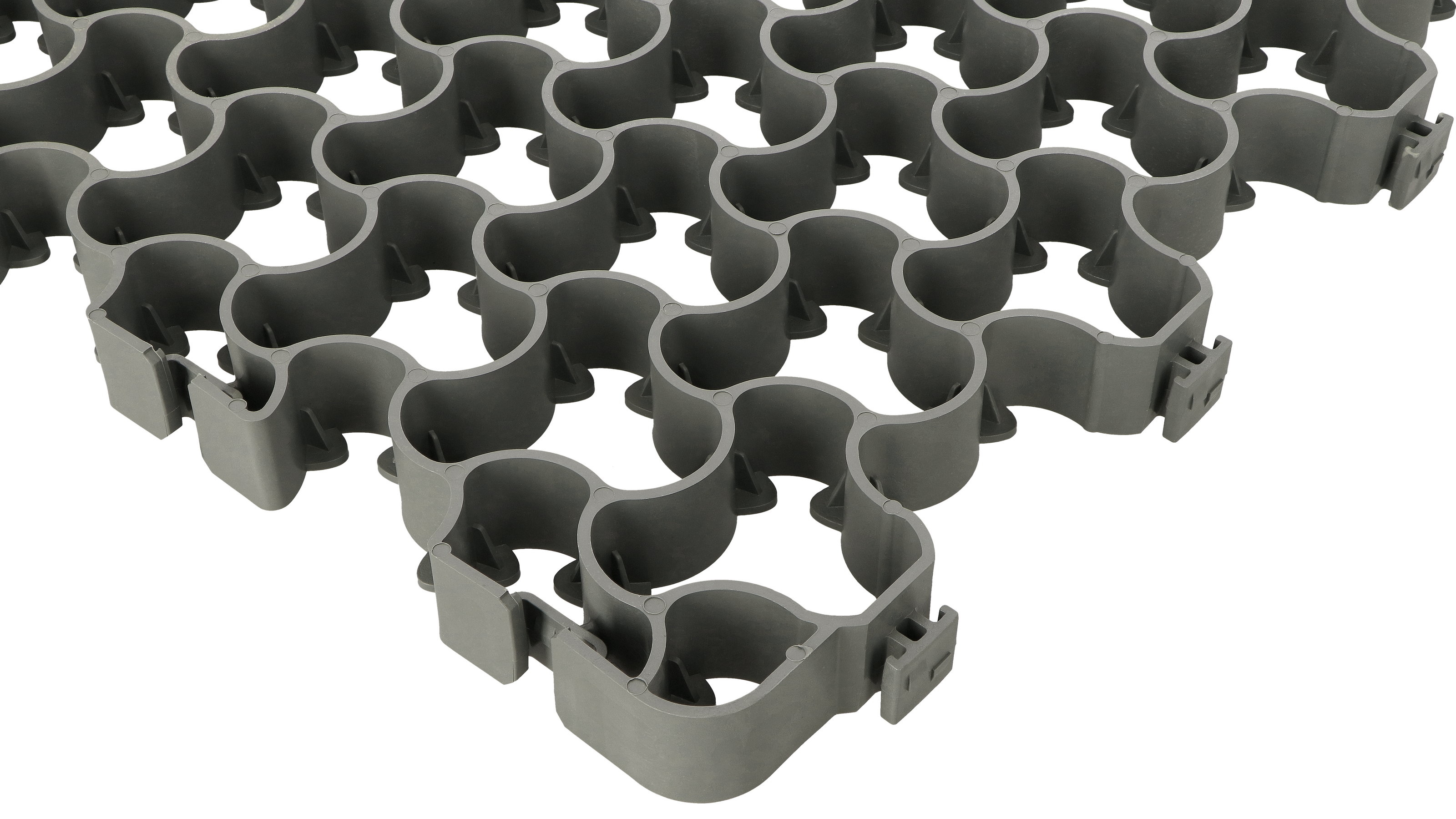 Interlocking metal lattice pattern with repeating clover-shaped cutouts, grey on white