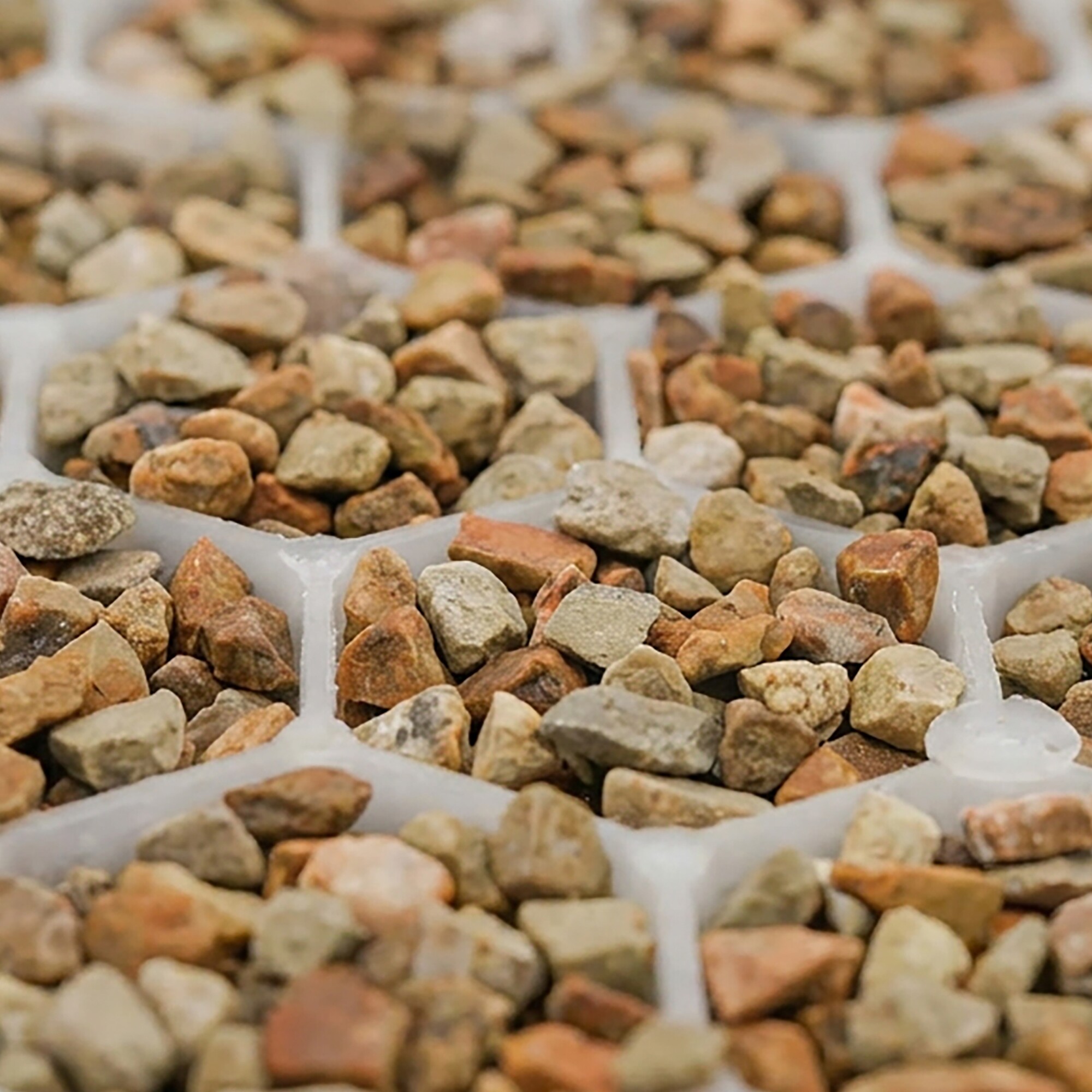 Close-up photo of small brown gravel stones on concrete surface